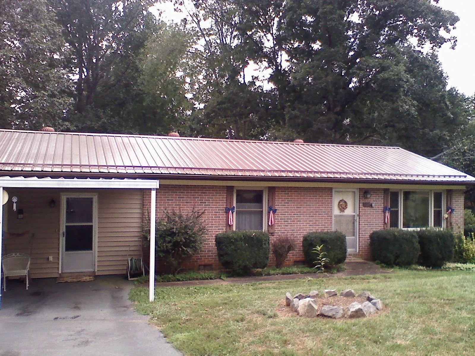 Bronze metal roof and carport on a brick ranch home — Roof Repair work by our crew in Naches